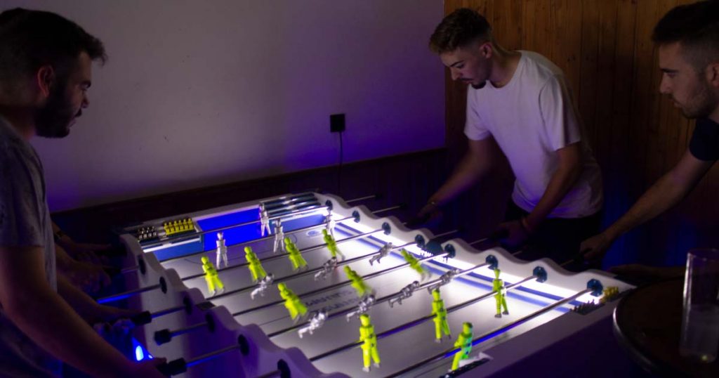 chicos jóvenes jugando al futbolín
